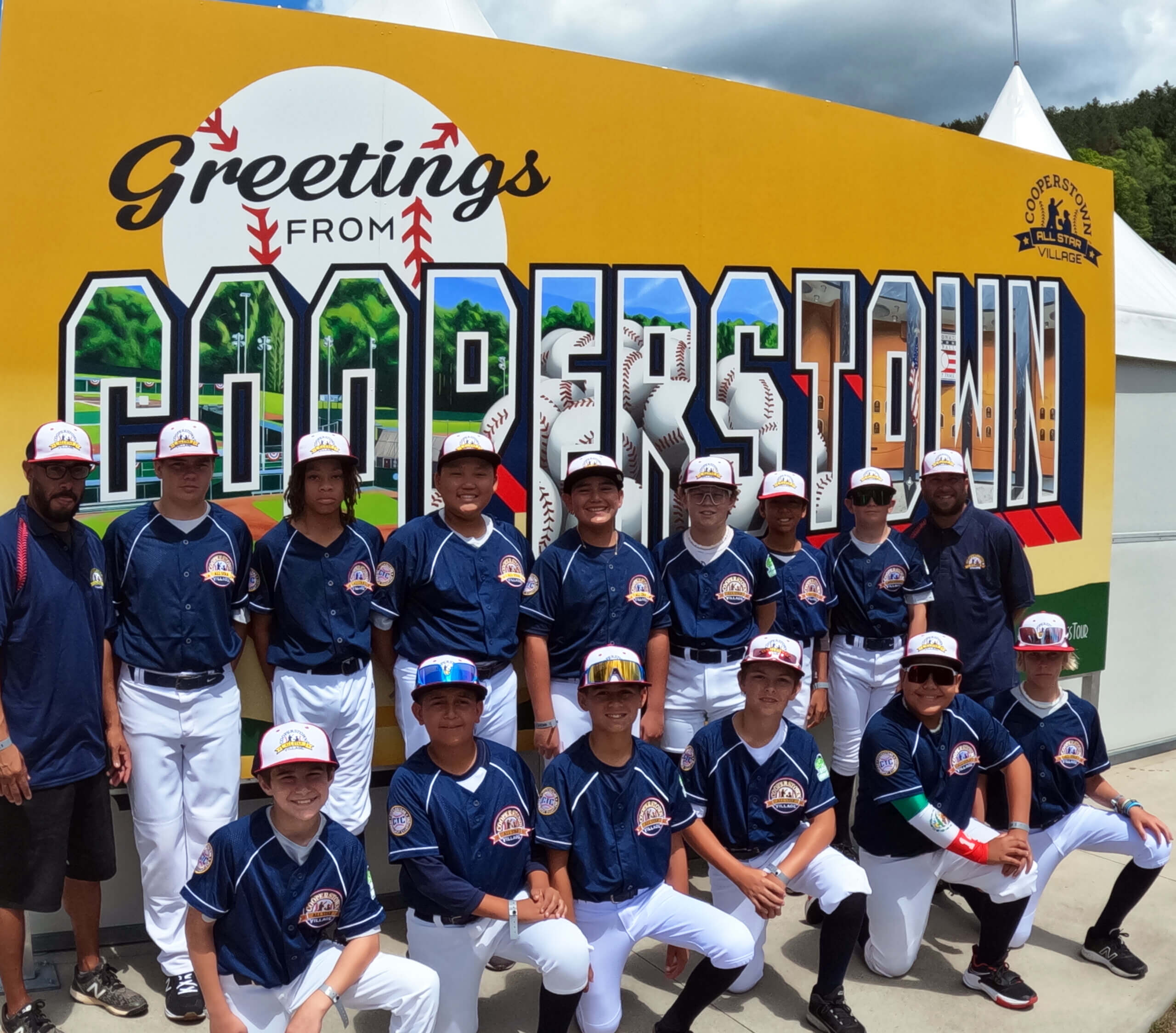 Baseball team in front of a cooperstown mural